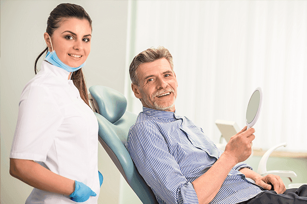 man seems to be happy after receiving the dental care